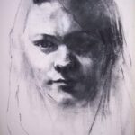 Charcoal Portrait of a girl's face with hint of a smile