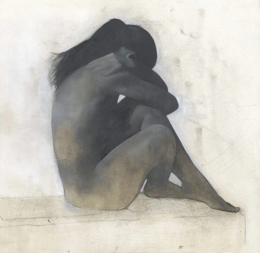 Figure seated in contemplative pose.