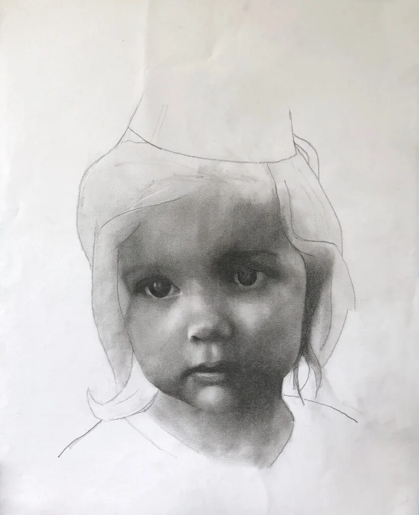 Home 2 A realistic pencil drawing of a young child’s face, partially shaded and unfinished at the top, showcases soft features and light hair. Perfect for those interested in figurative art commissions or personalized art commissions.